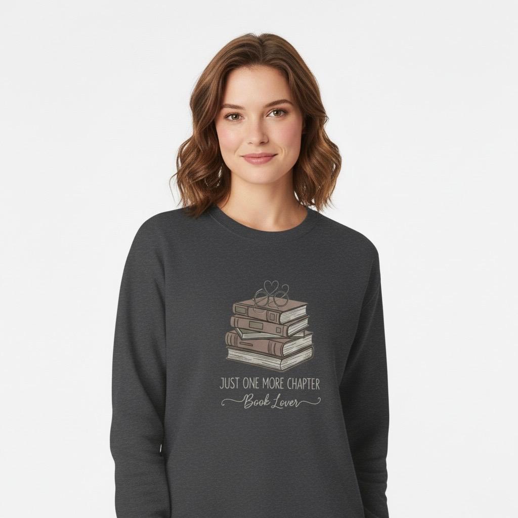 Person wearing a Dark Heather gray sweatshirt with a book-themed design on a white background